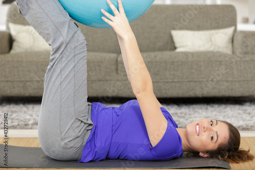young pregnant women doing yoga with yoga ball