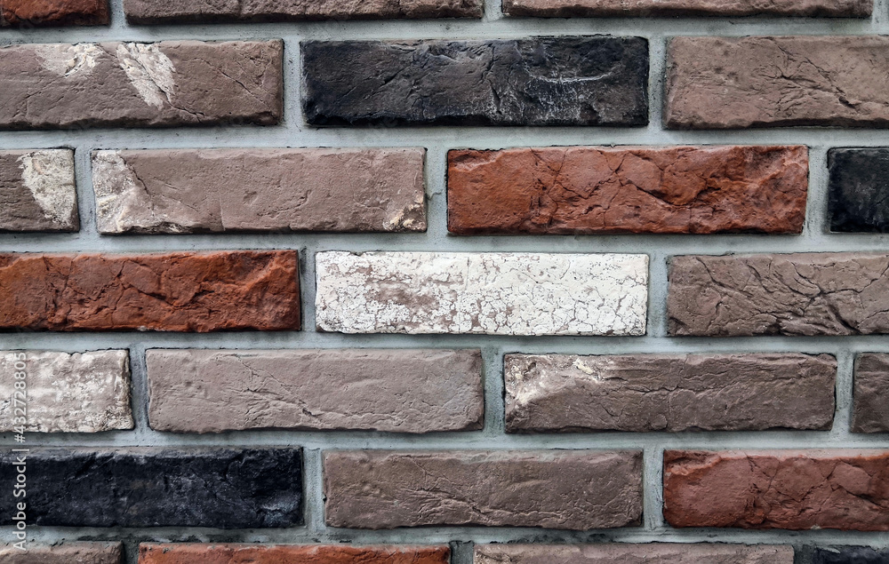 Wall background with red, brown, white and black bricks Wall background with red, brown, white and black bricks