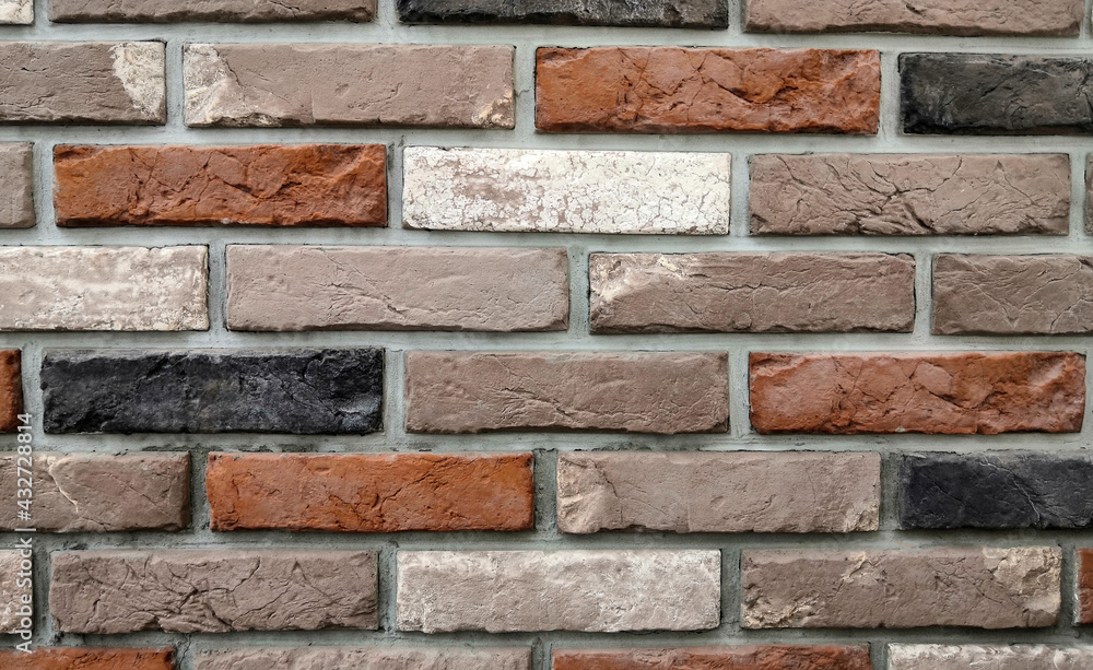 Wall background with red, brown, white and black bricks Wall background with red, brown, white and black bricks