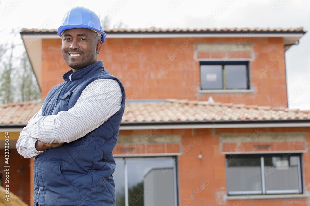 young workman with helmet keeping the arms crossed young workman with helmet keeping the arms crossed