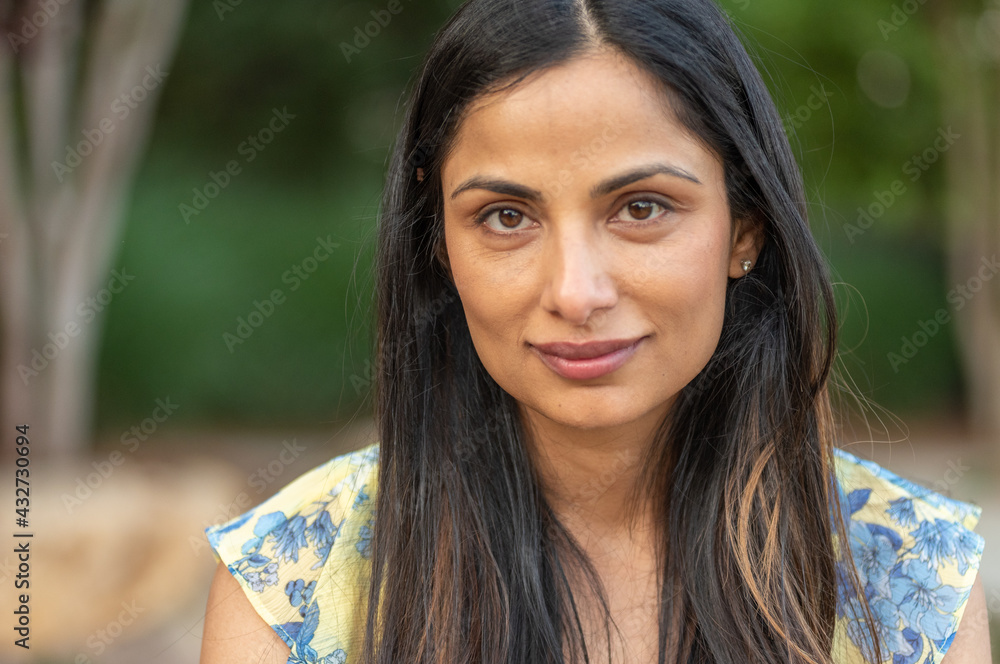 Beautiful Asian Indian woman sitting by a small creek Beautiful Asian Indian woman sitting by a small creek
