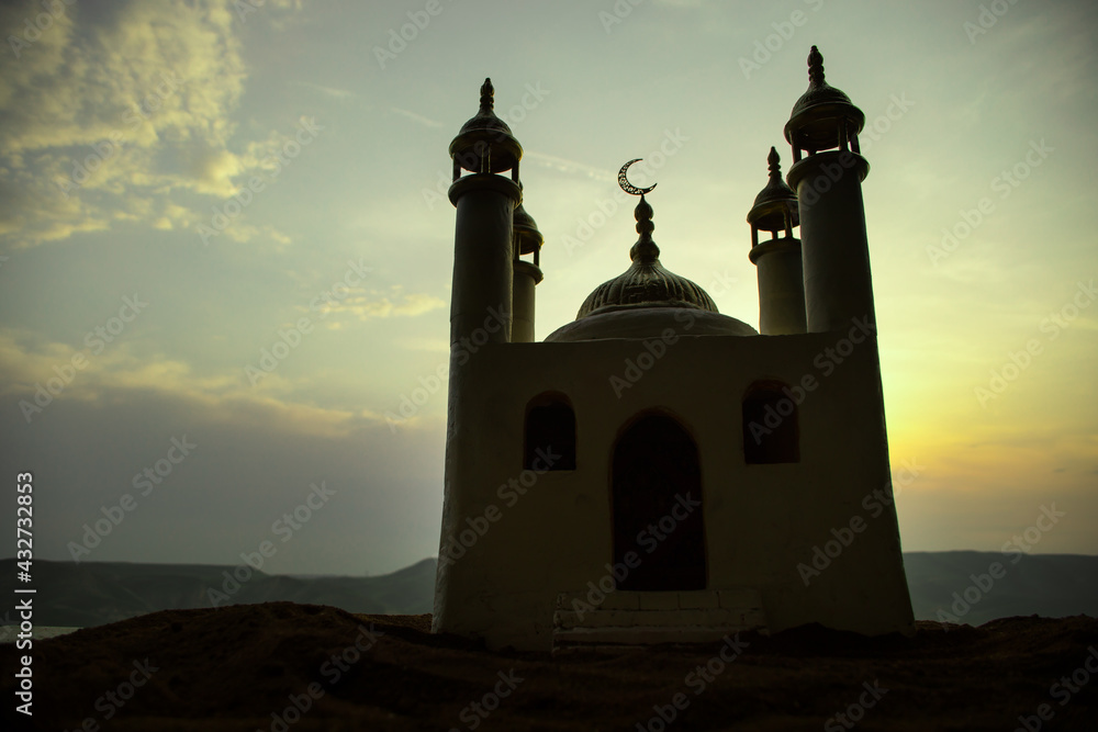 A realistic Mosque miniature with windows at night. Festive greeting card, invitation for Muslim holy month Ramadan Kareem. A realistic Mosque miniature with windows at night. Festive greeting card, invitation for Muslim holy month Ramadan Kareem.