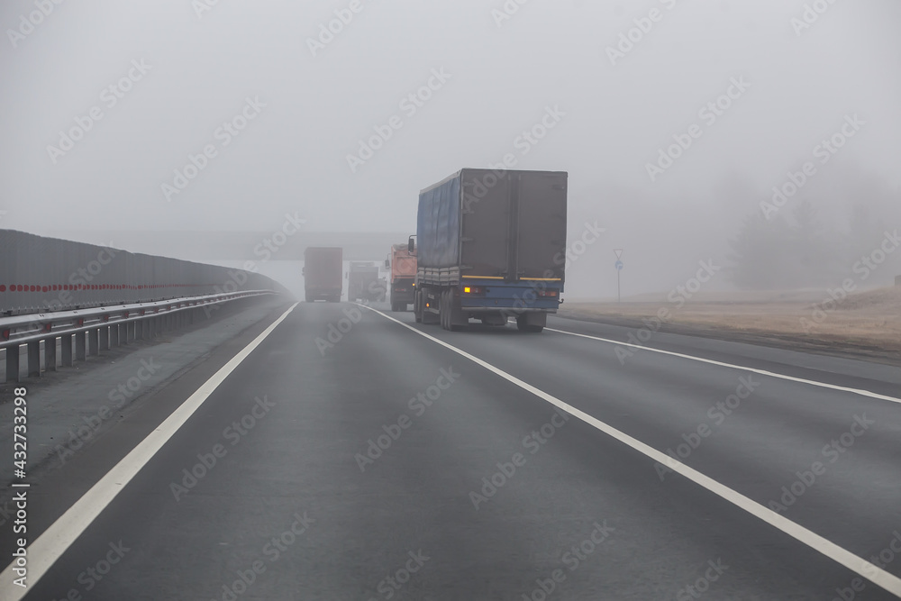 Trucks are moving in the fog