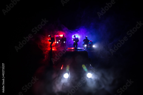 Fototapeta Naklejka Na Ścianę i Meble -  Police cars at night. Police car chasing a car at night with fog background. 911 Emergency response police car speeding to scene of crime.