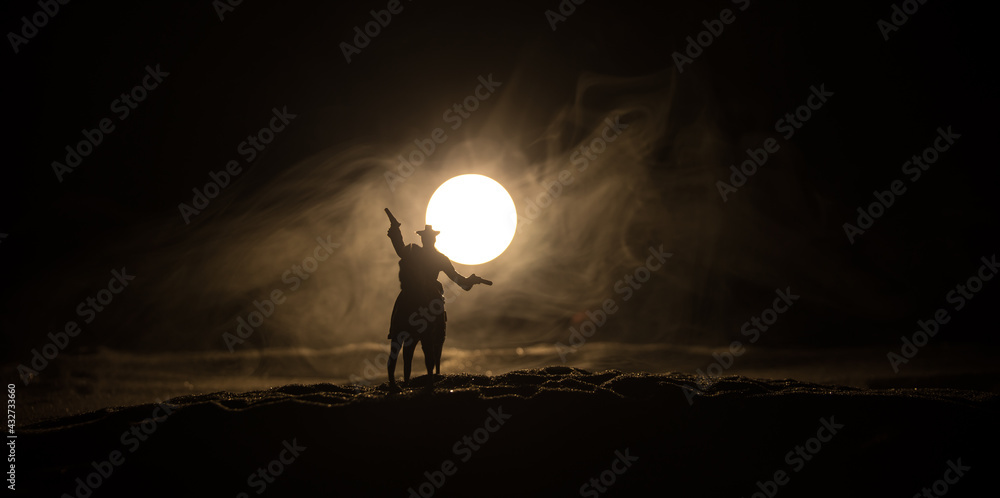 Western cowboy silhouette with texture at sunset and slivers of light Western cowboy silhouette with texture at sunset and slivers of light