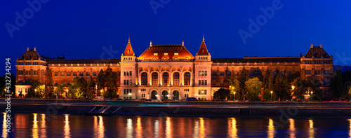 Hungary, Budapest at night, university building on the bank of the Danube, the reflection of lights in the water