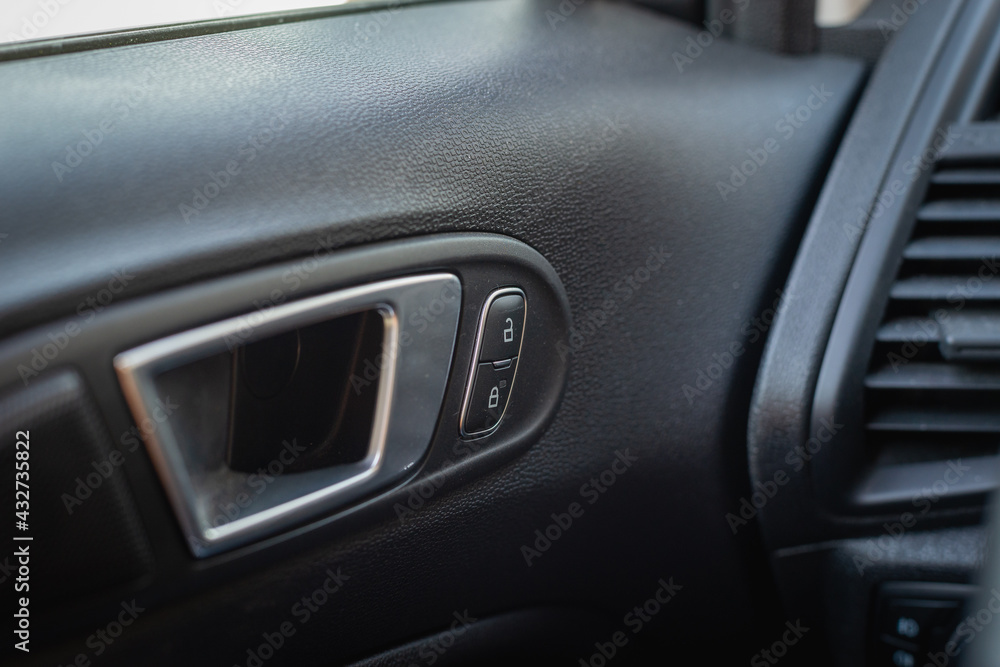 Car door handle with control buttons.
