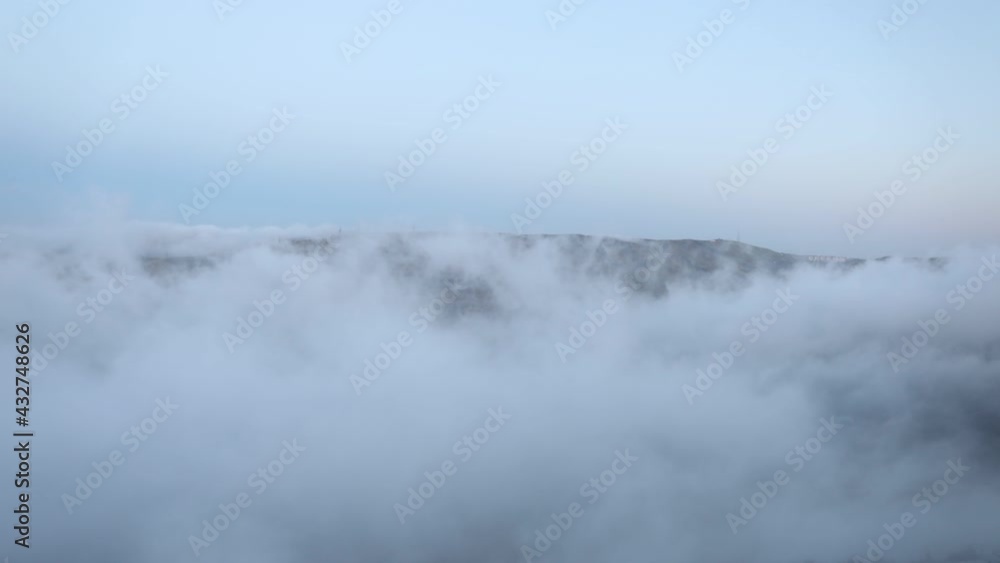 Beautiful clouds flying over the lake near mountains. Evening time shot over the clouds. Timelapse Beautiful clouds flying over the lake near mountains. Evening time shot over the clouds. Timelapse