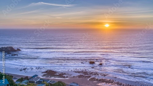 An idyllic scenery at Matanzas beach, the waves coming from the Pacific Ocean illuminated by a moody sky during sunset and with the beginning of twilight. Amazing landscape from the sea to the sky