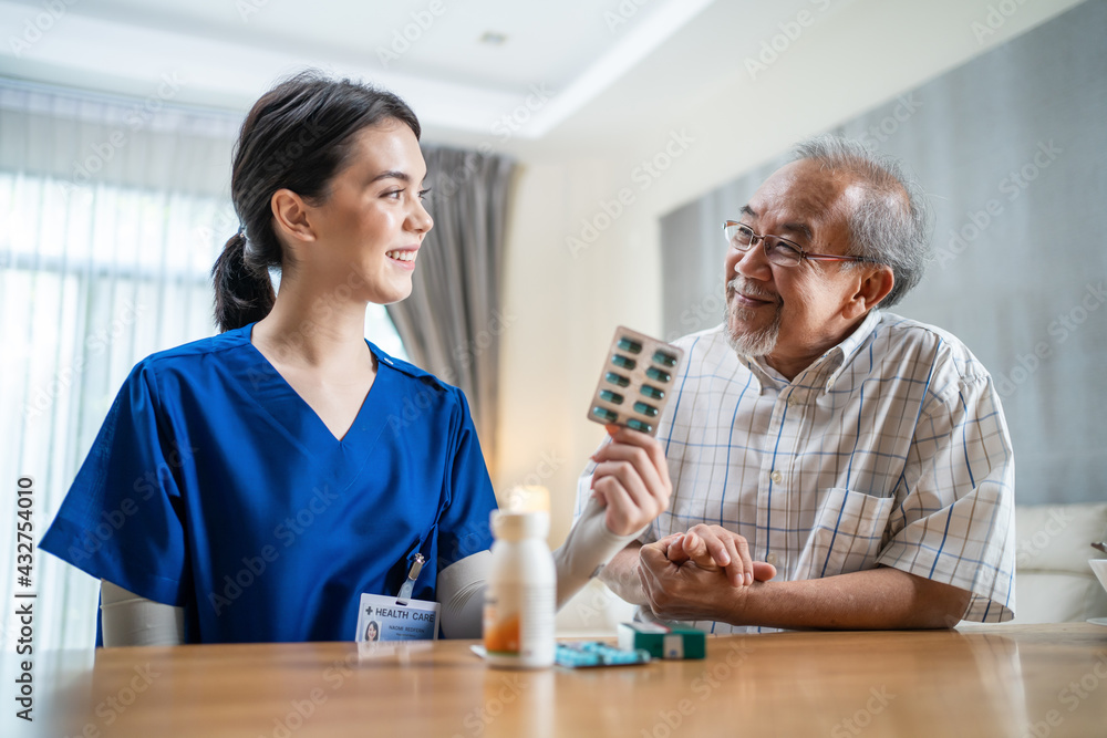 Asian nurse explaining old man to take medicine before or after meal. Asian nurse explaining old man to take medicine before or after meal.