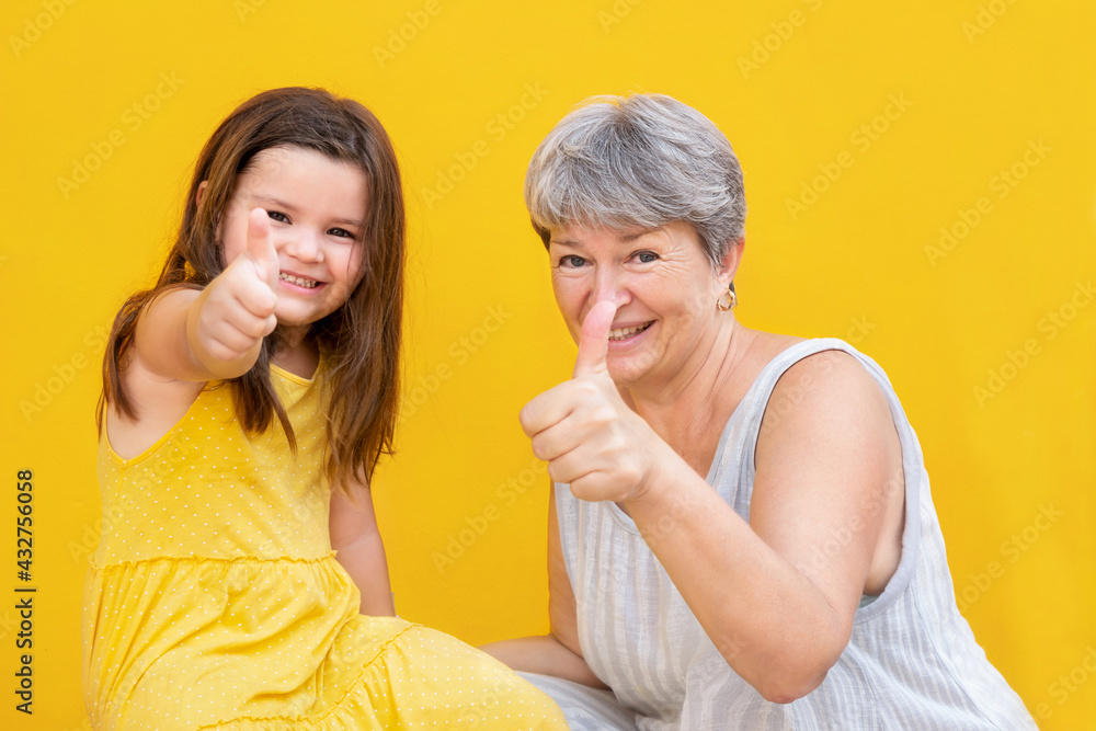 Grandmother and child show thumb up Grandmother and child show thumb up