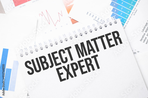 SUBJECT MATTER EXPERT text on paper on the chart background with pen