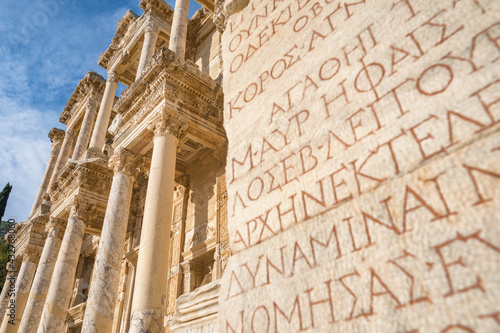 Ancient greek inscriptions on the wall of Celsus Library in the Ephesus ancient city, Turkey photo