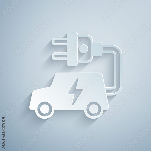 Paper cut Electric car and electrical cable plug charging icon isolated on grey background. Renewable eco technologies. Paper art style. Vector