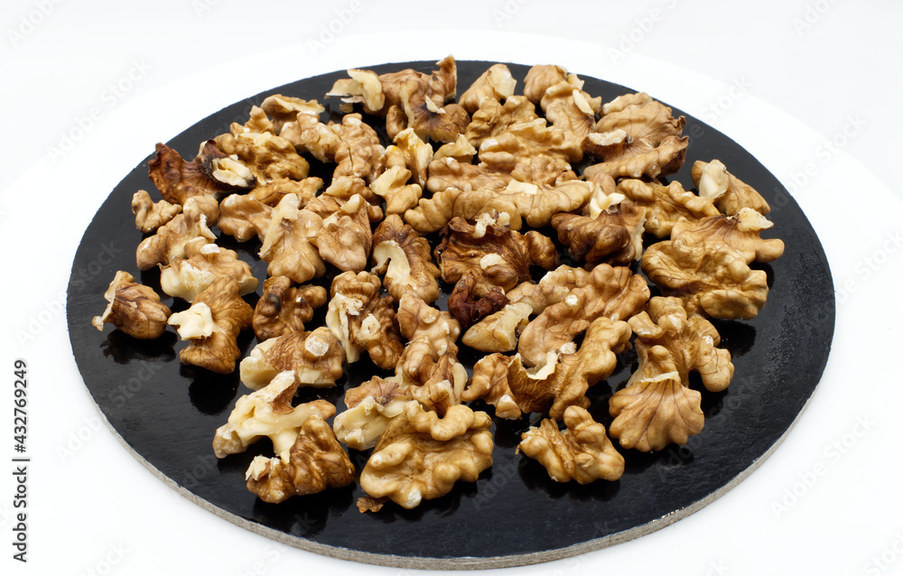 Walnut pile out its shell isolated on white background. Walnut kernels close up Walnut pile out its shell isolated on white background. Walnut kernels close up