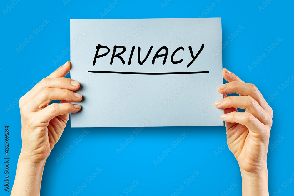 Hands of a woman holding a cardboard with the word Privacy Hands of a woman holding a cardboard with the word Privacy