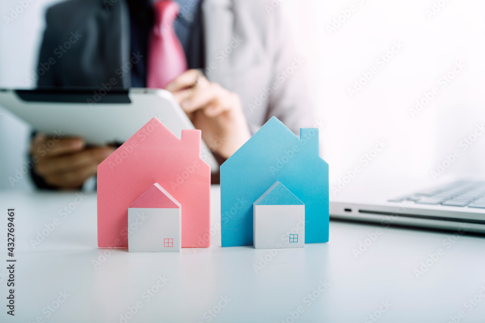 Model house and architectural project: real estate, relocation and home purchase concept Model house and architectural project: real estate, relocation and home purchase concept