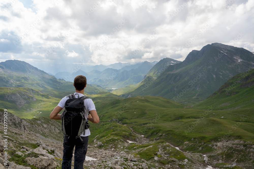 Young hiker look at the wonderful panorama in the swiss alps