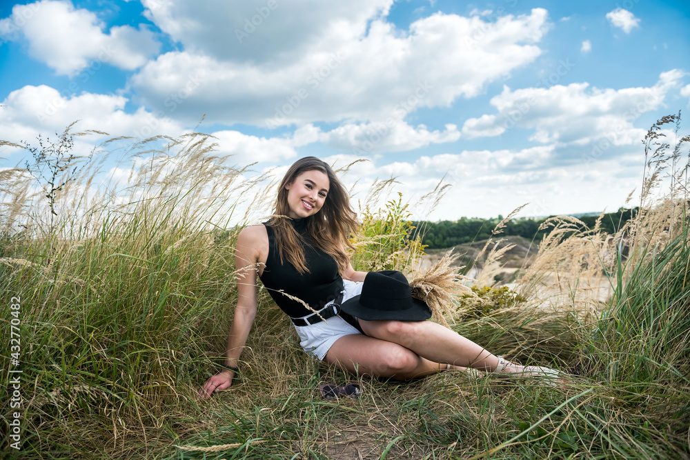 Pretty slim younf woman walking in green rural field Pretty slim younf woman walking in green rural field