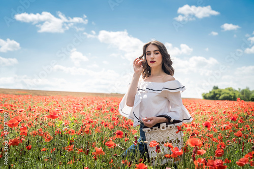 portrait of beauty and fashion girl in poppy field