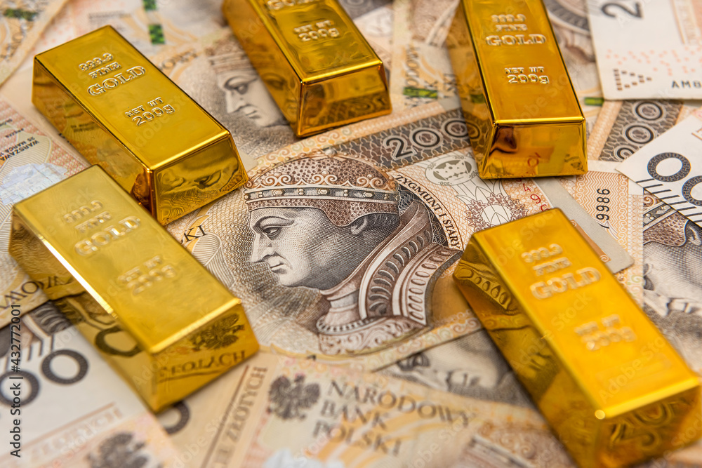 shiny gold bar on polish zloty. investment and financial concept shiny gold bar on polish zloty. investment and financial concept