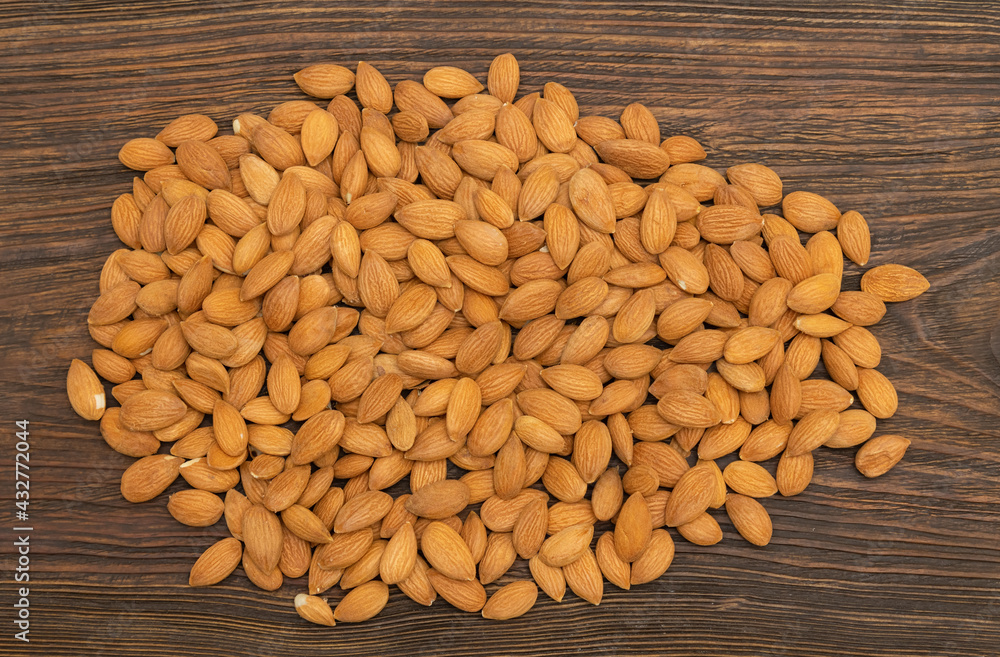 Top view dry nuts from an apricot kernel on a wooden table. Top view dry nuts from an apricot kernel on a wooden table.