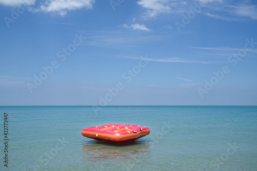 Inflatable ring or lilo in the sea by the beach. Summer or vacation concept.