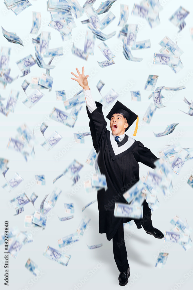 Happy male graduate student running under money rain Happy male graduate student running under money rain