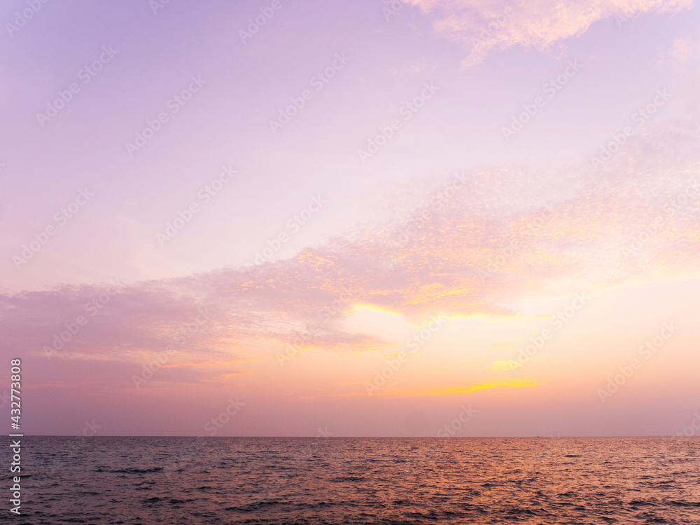 Peaceful sea scape and golden purple tone sunset or sunrise sky, tropical island ocean view at dawn or dusk Peaceful sea scape and golden purple tone sunset or sunrise sky, tropical island ocean view at dawn or dusk