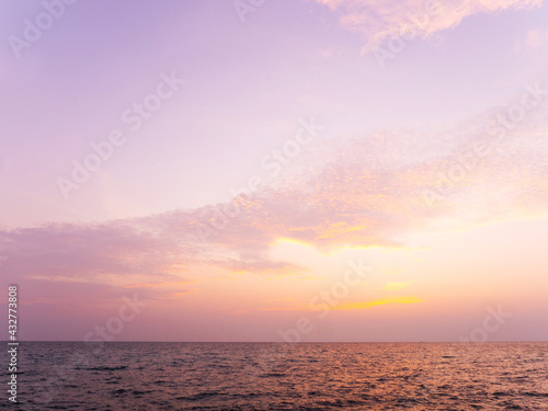 Peaceful sea scape and golden purple tone sunset or sunrise sky, tropical island ocean view at dawn or dusk © PixHound