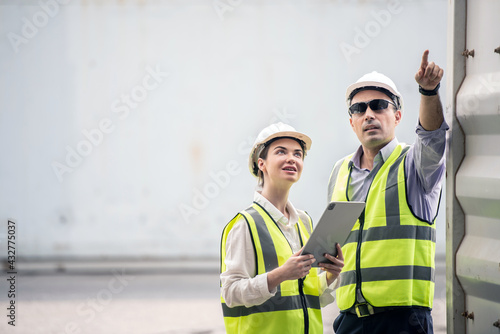 Boss and worker woman checking products results on the tablet at logistic and Explain for understanding about products.