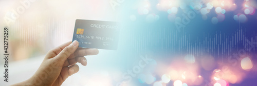 Принти на полотні hand holding credit card Trading ideas, payout ideas, stock market and blur background