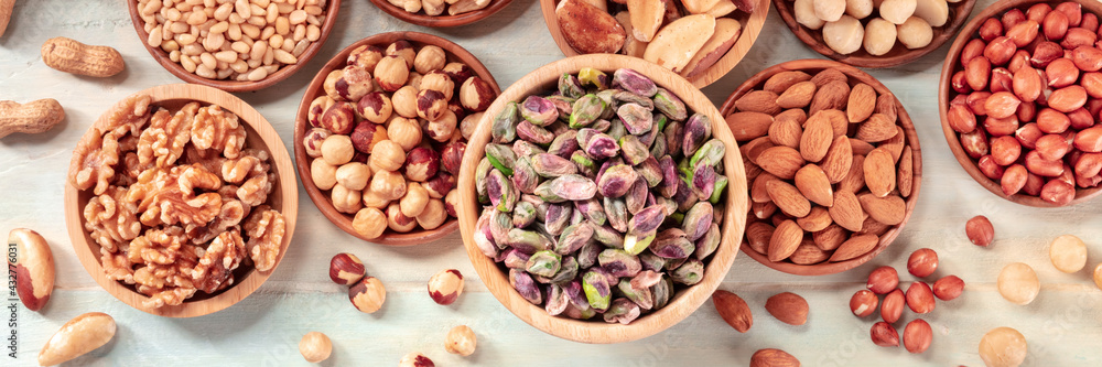 Nut panorama. Various nuts, shot from the top on a rustic background Nut panorama. Various nuts, shot from the top on a rustic background