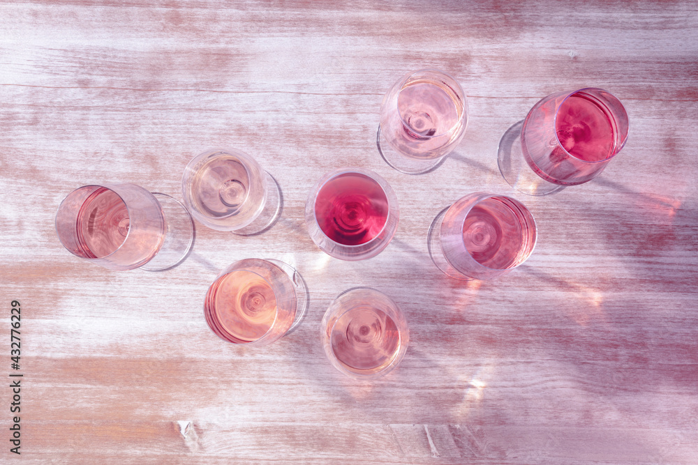 Rose wine types, shot from above, toned in pink, many glasses of wine - obrazy, fototapety, plakaty 