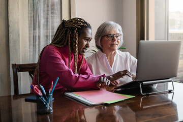 Multiracial senior and young business people with working inside modern office - Focus on african woman face