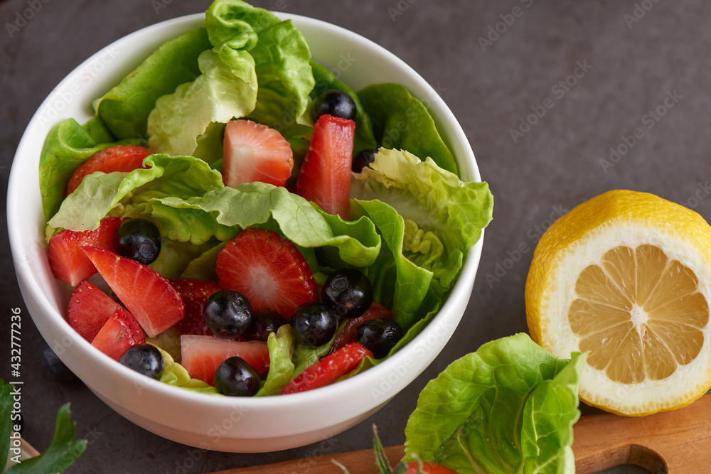 Healthy strawberries salad with butterhead, blackberry in a white plate. Healthy strawberries salad with butterhead, blackberry in a white plate.