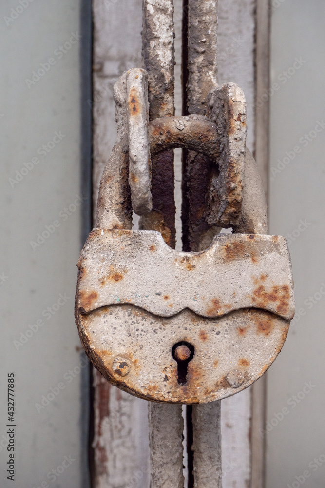 A dirty old lock covered with rust for barns and other doors A dirty old lock covered with rust for barns and other doors