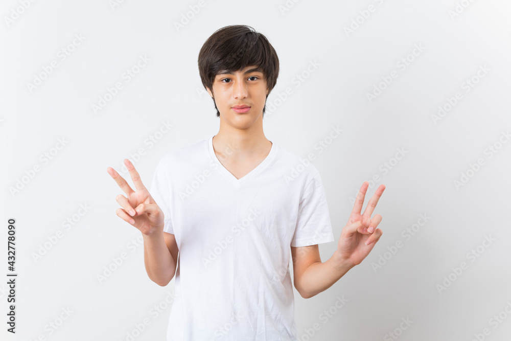 Smiling Caucasian boy portrait isolated on white background. Beautiful teen male model with thumb up finger posing. Smiling Caucasian boy portrait isolated on white background. Beautiful teen male model with thumb up finger posing.