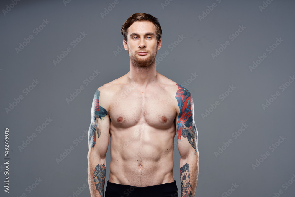 sporty man with tattoos on his arms workout cropped view