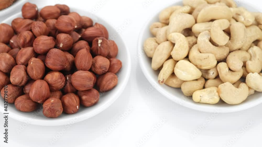 nuts pecans, almonds, hazelnuts on white background, rotation. 4K UHD video nuts pecans, almonds, hazelnuts on white background, rotation. 4K UHD video