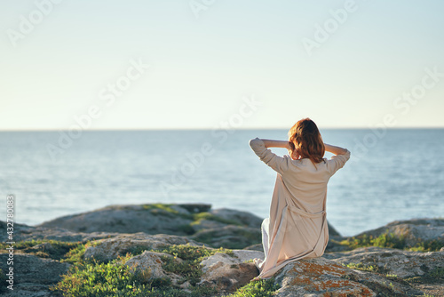 romantic woman in the mountains near the sea on nature landscape
