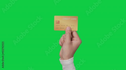 Woman customer hands holding credit card on chroma key green screen background.