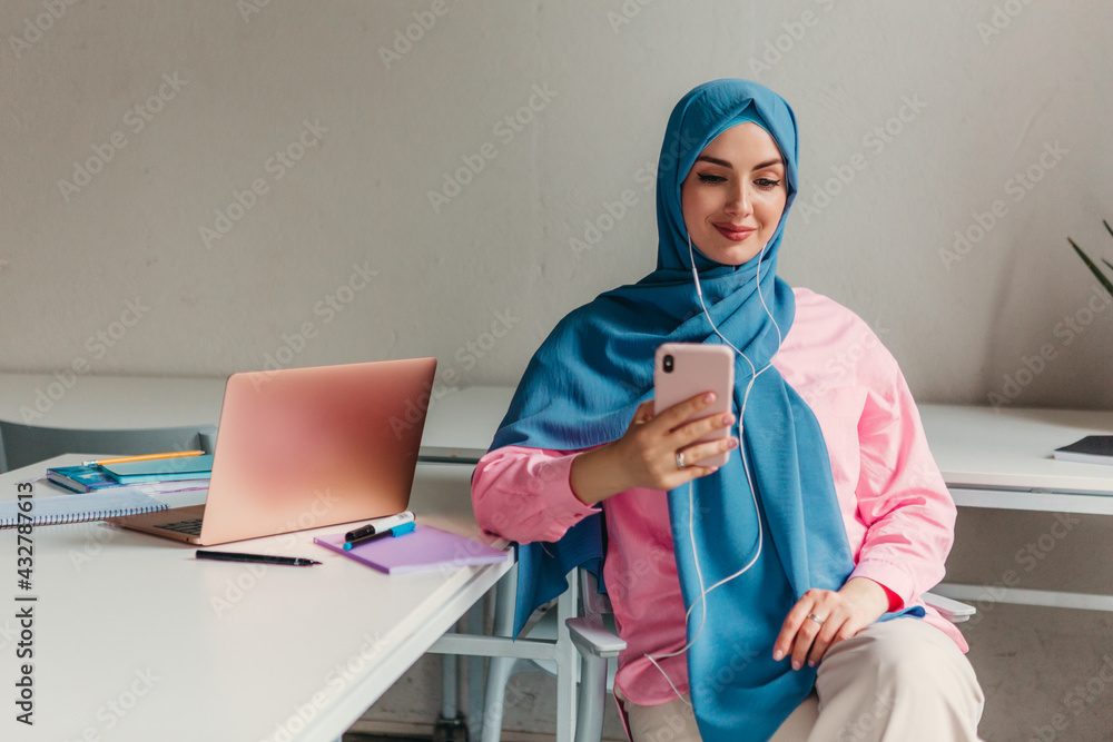 muslim woman in hijab working in office room