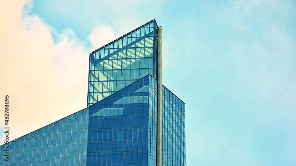 Modern building in the city with sunlight. Abstract texture and blue glass facade in modern office building., Retro stylized colorful tonal filter effect.