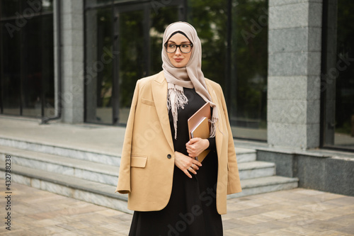 modern stylish muslim woman in hijab in city street © mary_markevich