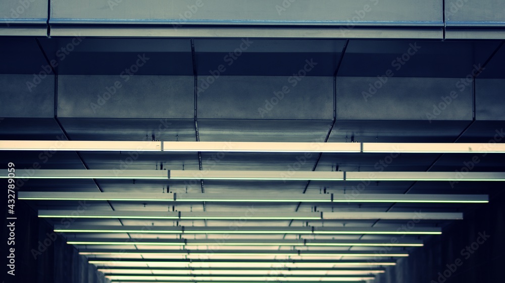 Obraz premium A fragment of the steel and glass metal facade of building. Detail architecture steel and glass facade on clear blue sky background. Modern architecture building facade with balconies. Retro filter.