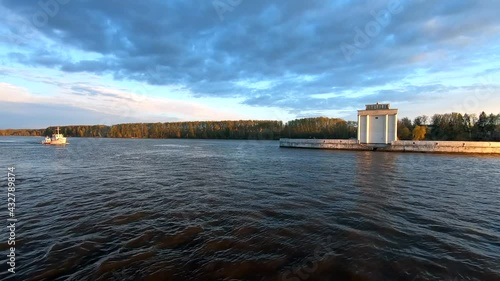 Wallpaper Mural Passing the yacht along the river at sunset. Beautiful colorful landscape of the river against the background of the blue sky at sunset. Traveling by ship on the river. Torontodigital.ca