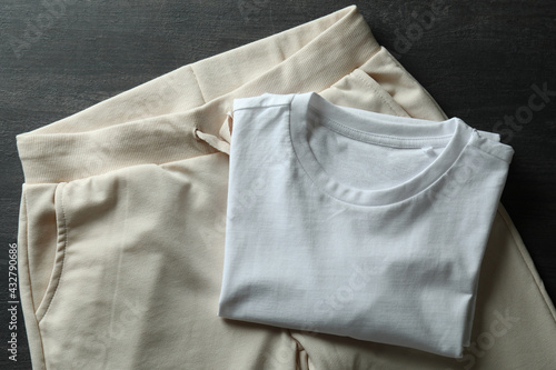 White t-shirt and sweatpants on dark wooden background
