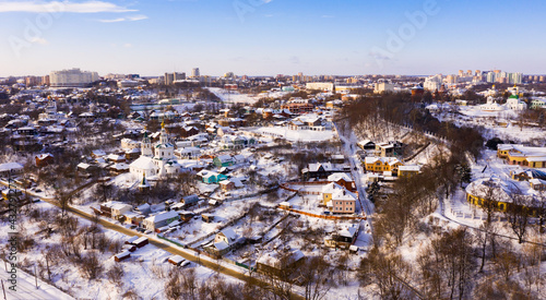 Aerial view of old historic district of Vladimir city with snow covered houses and churches on sunny winter day  Russia