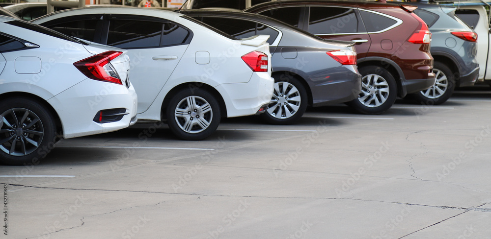 Closeup of rear, back side of white car with other cars parking in indoor parking area. Closeup of rear, back side of white car with other cars parking in indoor parking area.